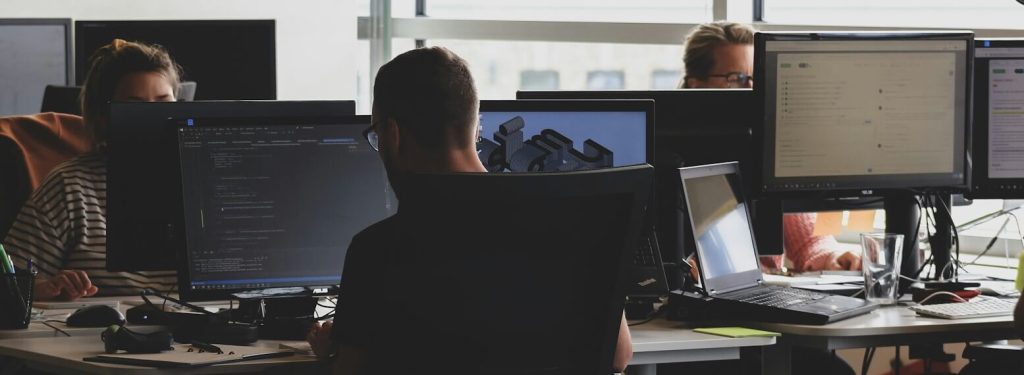 Photo of software developer writing code in an office - photo by rivage on Unsplash